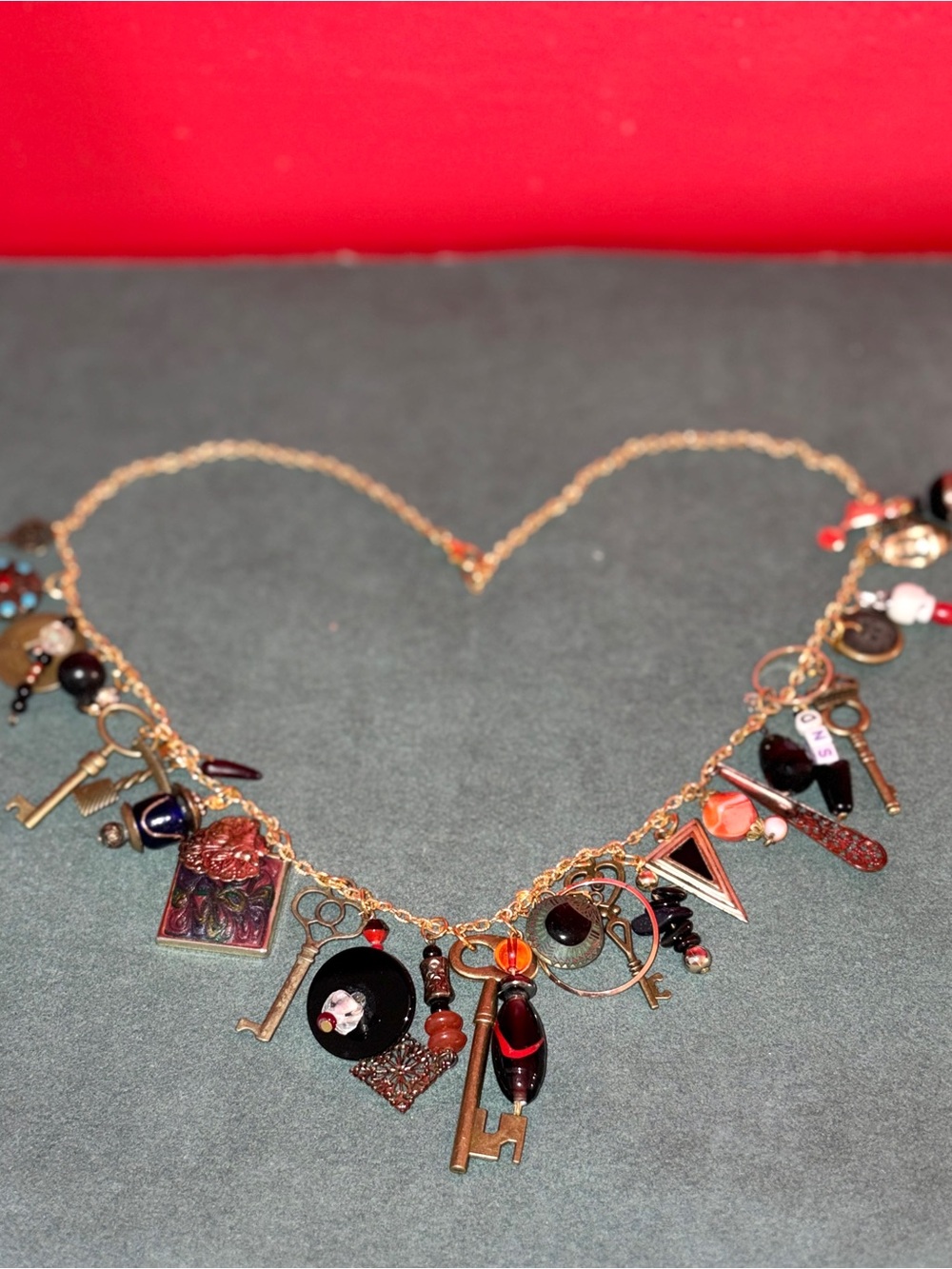 Hand Crafted Gold-Tone Charm Necklace with Red and Black Accents